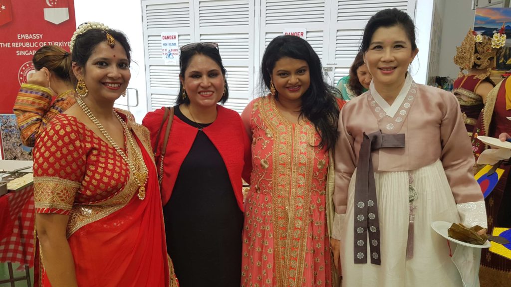 four women standing in a room happily