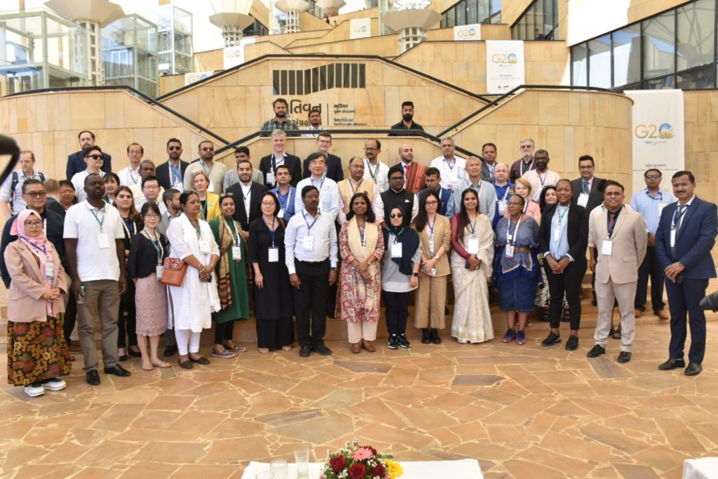 a bunch of people posing in front of a symmetrical stair/infrastructure